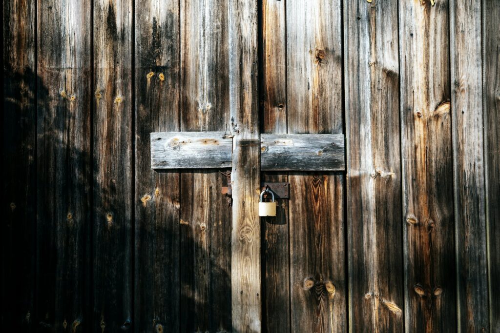 A key in the lock of a weathered wooden door