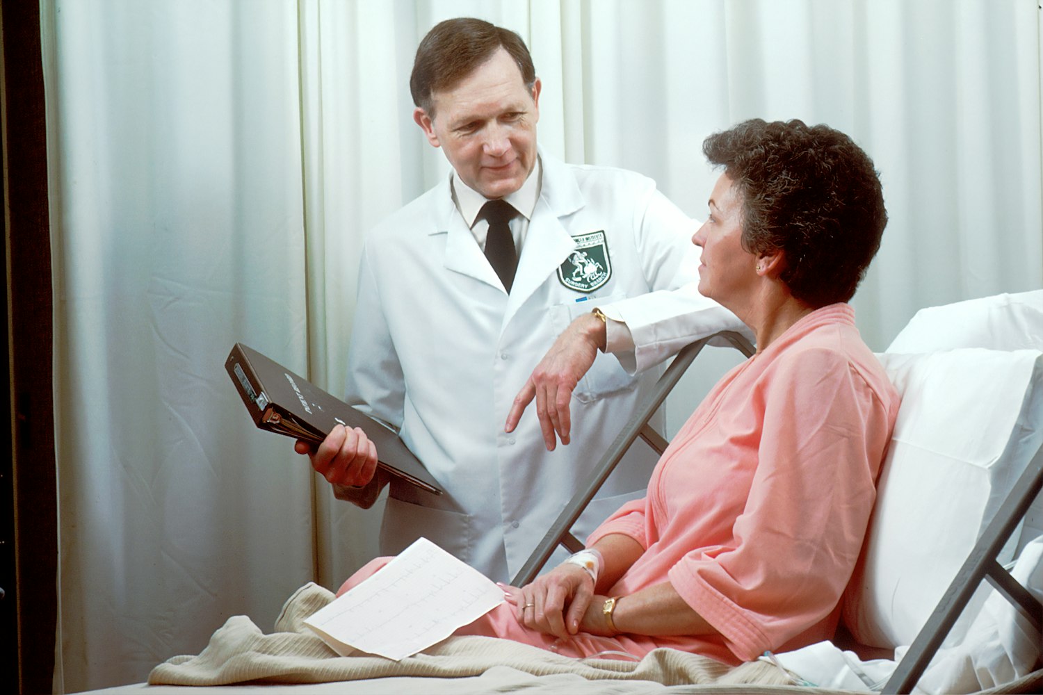 A provider holding a tablet during a clinical interview