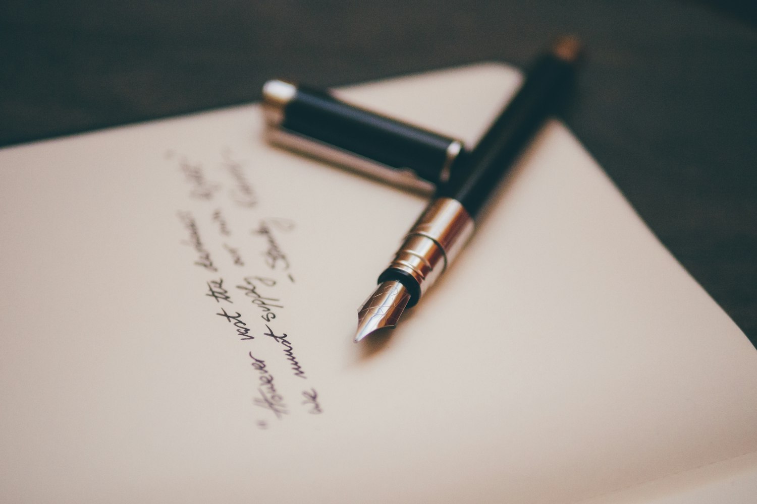 A pen resting on paper, representing signing a membership application
